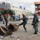 Police officers join civilians in removing barricades from a street in Ikeja, as Nigeria’s Lagos state remains under curfew. Oct. 23, 2020.